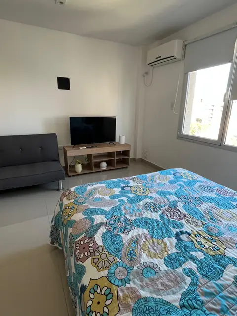 Living con sillón, Smart TV y cama